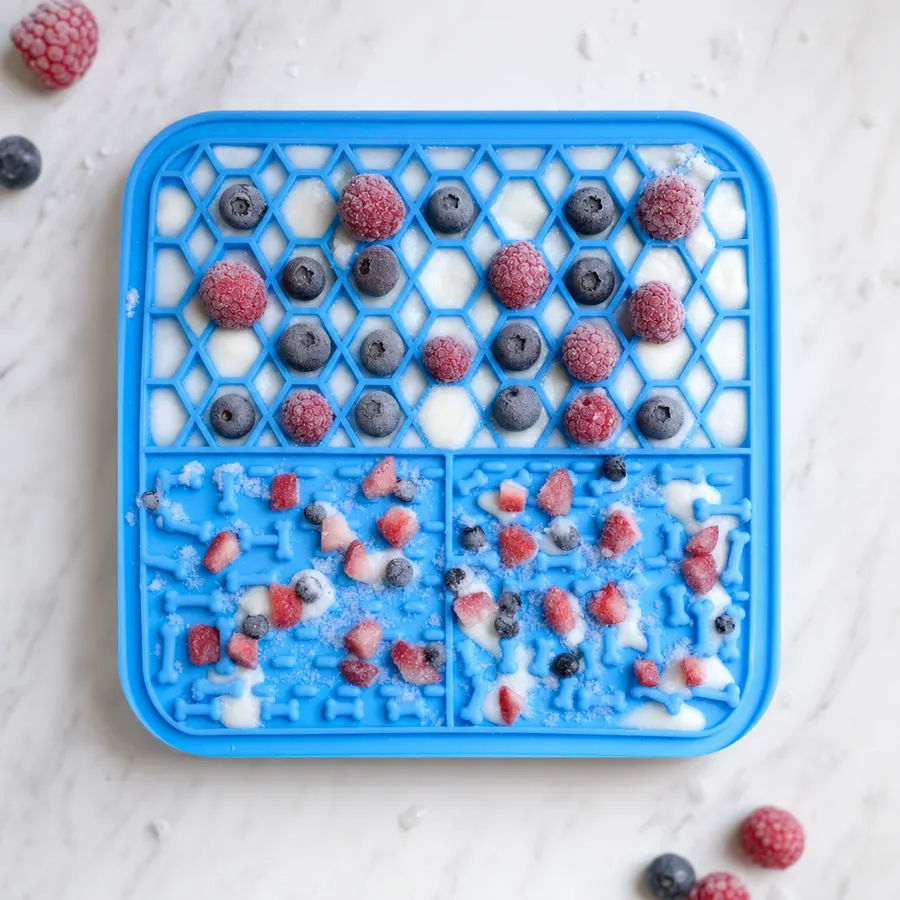 Frozen lick mat with a layer of yogurt and fruit ready to serve on a hot day